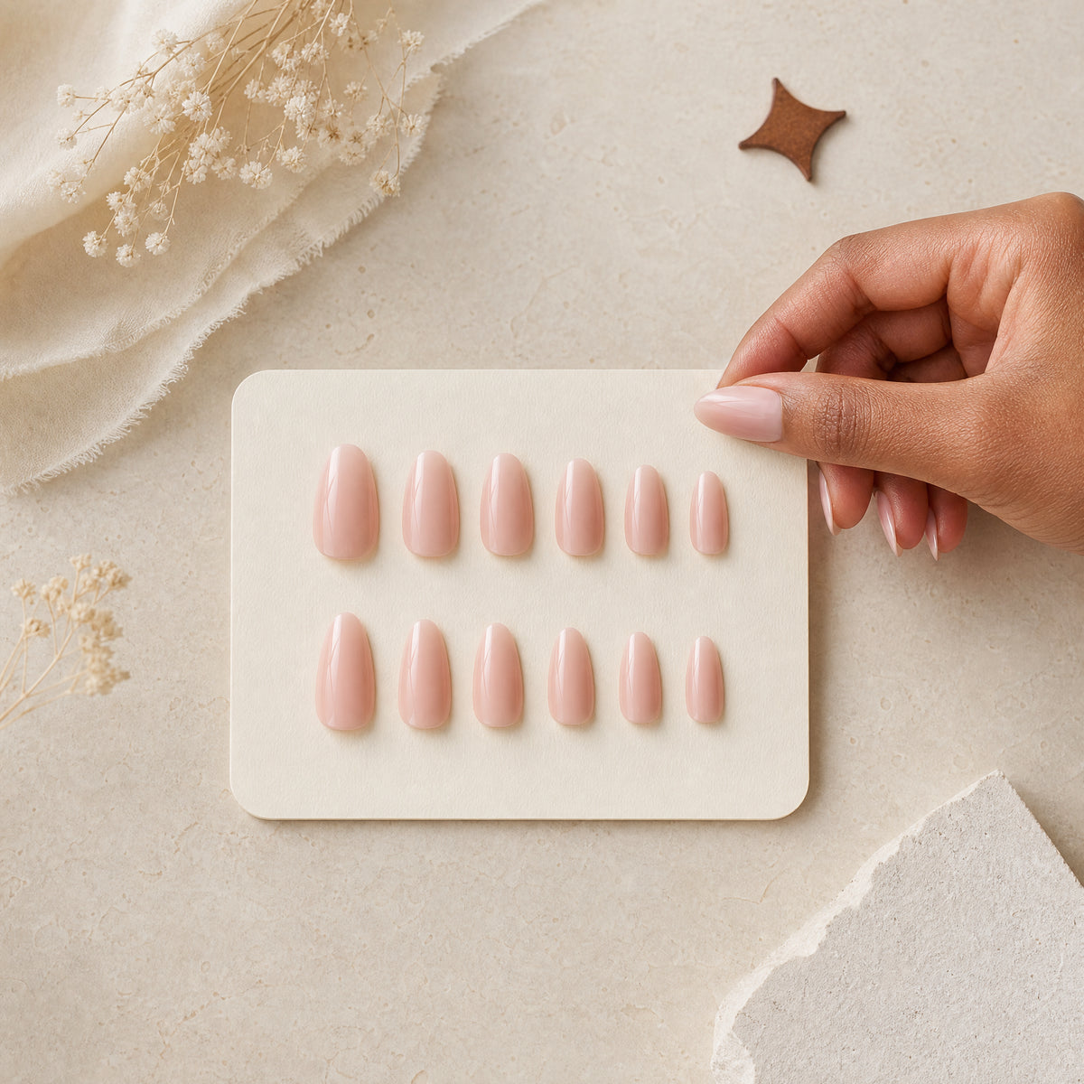 A blush press-on nail sizing set arranged for choosing the right fit